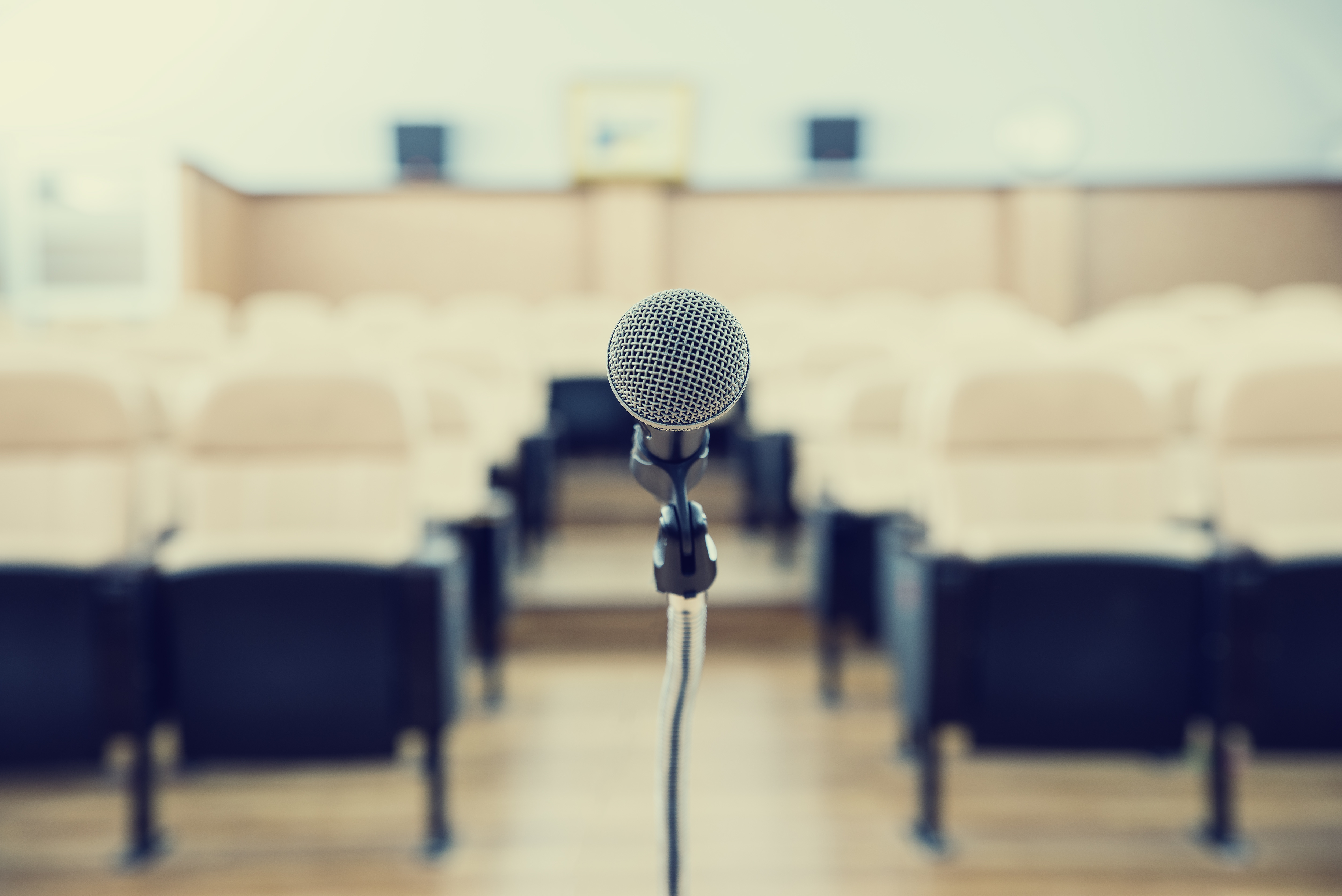 before a conference, the microphones in front of empty chairs.